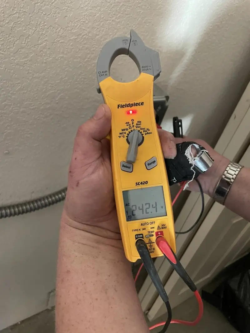 Voltage testing with clamp meter during Outlet Installation in Warrington